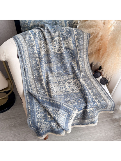 Blue Gray paisley scarf with fringed edges draped over a chair