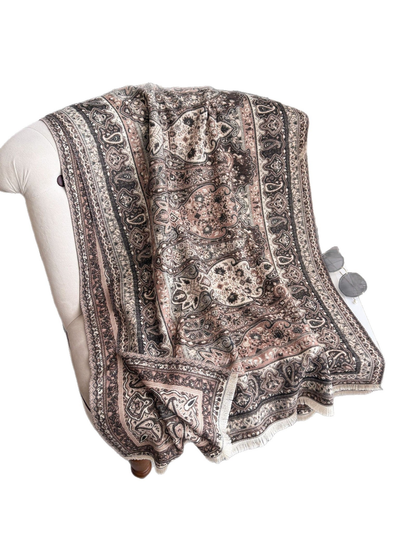 Paisley scarf with fringed edges draped over a chair