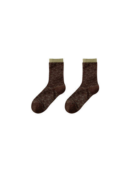 Green Cuff socks in dark brown with small pale motifs and an olive-green cuff