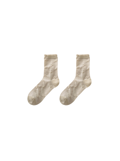 Bow Motif cream socks with scattered bow-shaped motifs and a ruffled cuff
