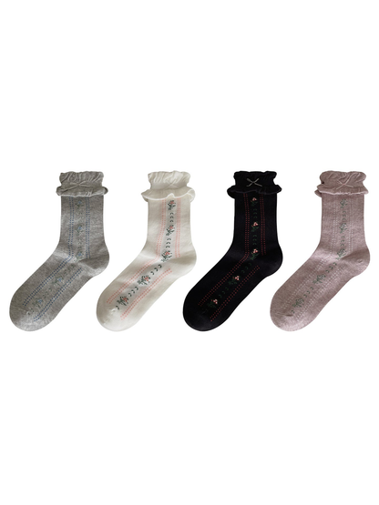 Black, gray, white, and light purple floral socks with dotted stripes displayed together