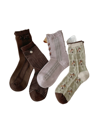 Brown, light purple, mint, and dark brown socks arranged together
