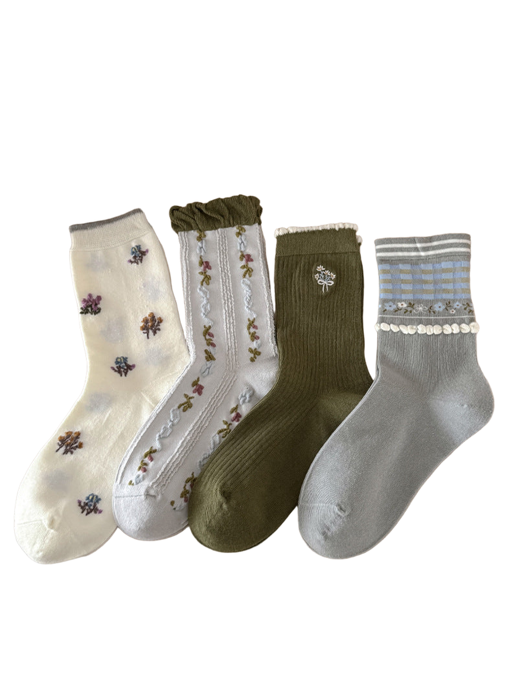 Four floral crew sock styles displayed together on a tabletop