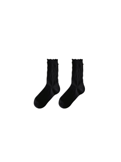 Black ruffled crew socks with pearl-like cuff embellishments