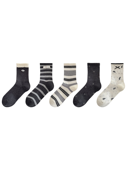Five crew socks displayed in a row on a white background