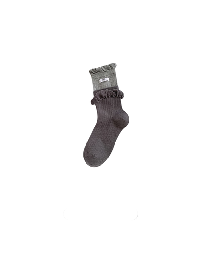 Ruffled heathered purple sock with ribbed texture and layered cuff