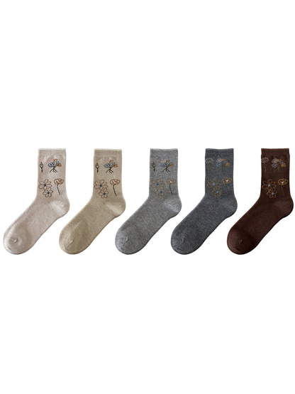 Five floral crew socks arranged side by side on a white background