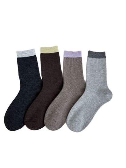 Four crew-length socks in dark charcoal, dark brown, taupe, and light gray with contrasting cuffs