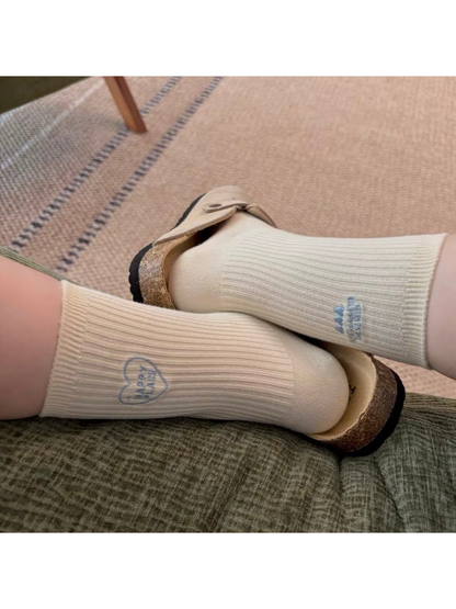 Ivory ribbed socks worn with platform sandals