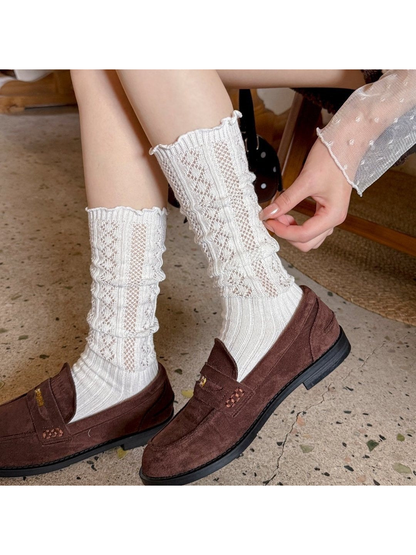 White patterned socks worn with brown loafers