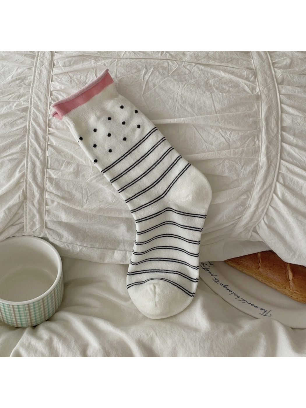 White crew sock with polka dots and horizontal stripes