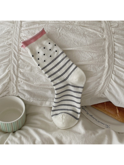 White crew sock with polka dots and horizontal stripes