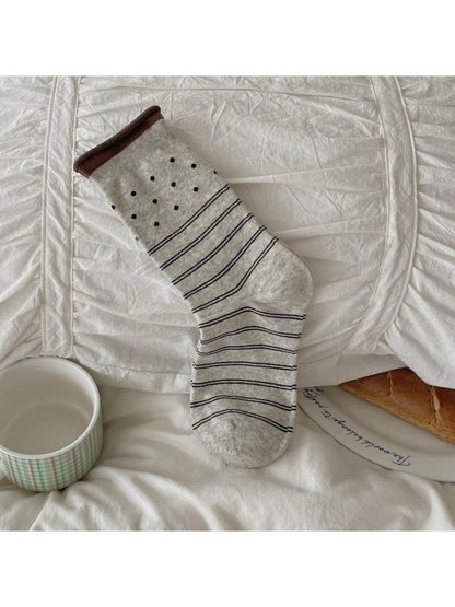 Light gray crew sock with polka dots and horizontal stripes