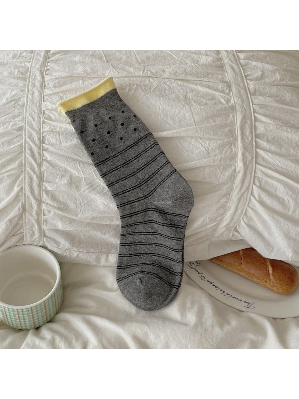 Dark gray crew sock with polka dots and horizontal stripes