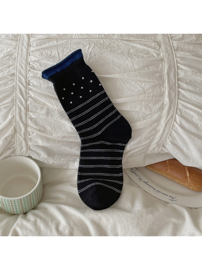 Black crew sock with polka dots and horizontal stripes