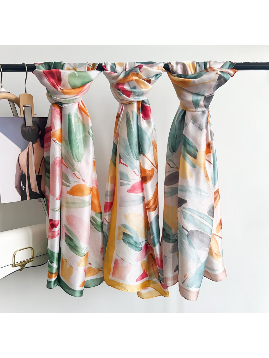Three floral scarves displayed together on a rack