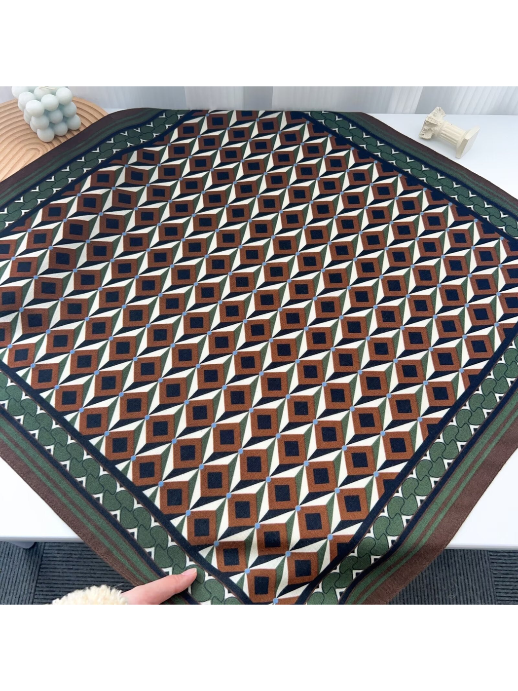 Brown, cream, green, and navy geometric square scarf laid flat