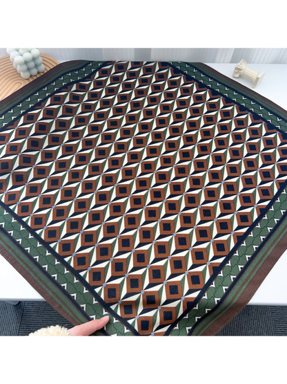 Brown, cream, green, and navy geometric square scarf laid flat