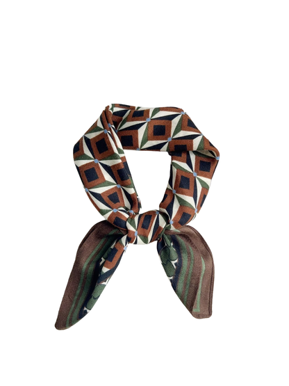 Brown, cream, green, and navy geometric square scarf tied in a bow