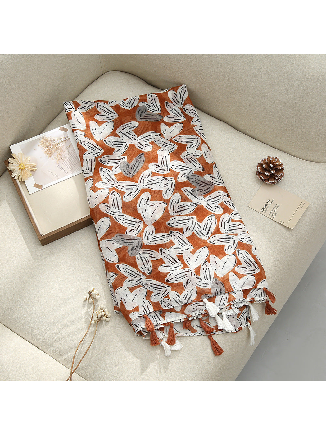 Orange Red scarf displayed flat with abstract butterfly-like motifs and tassel fringe