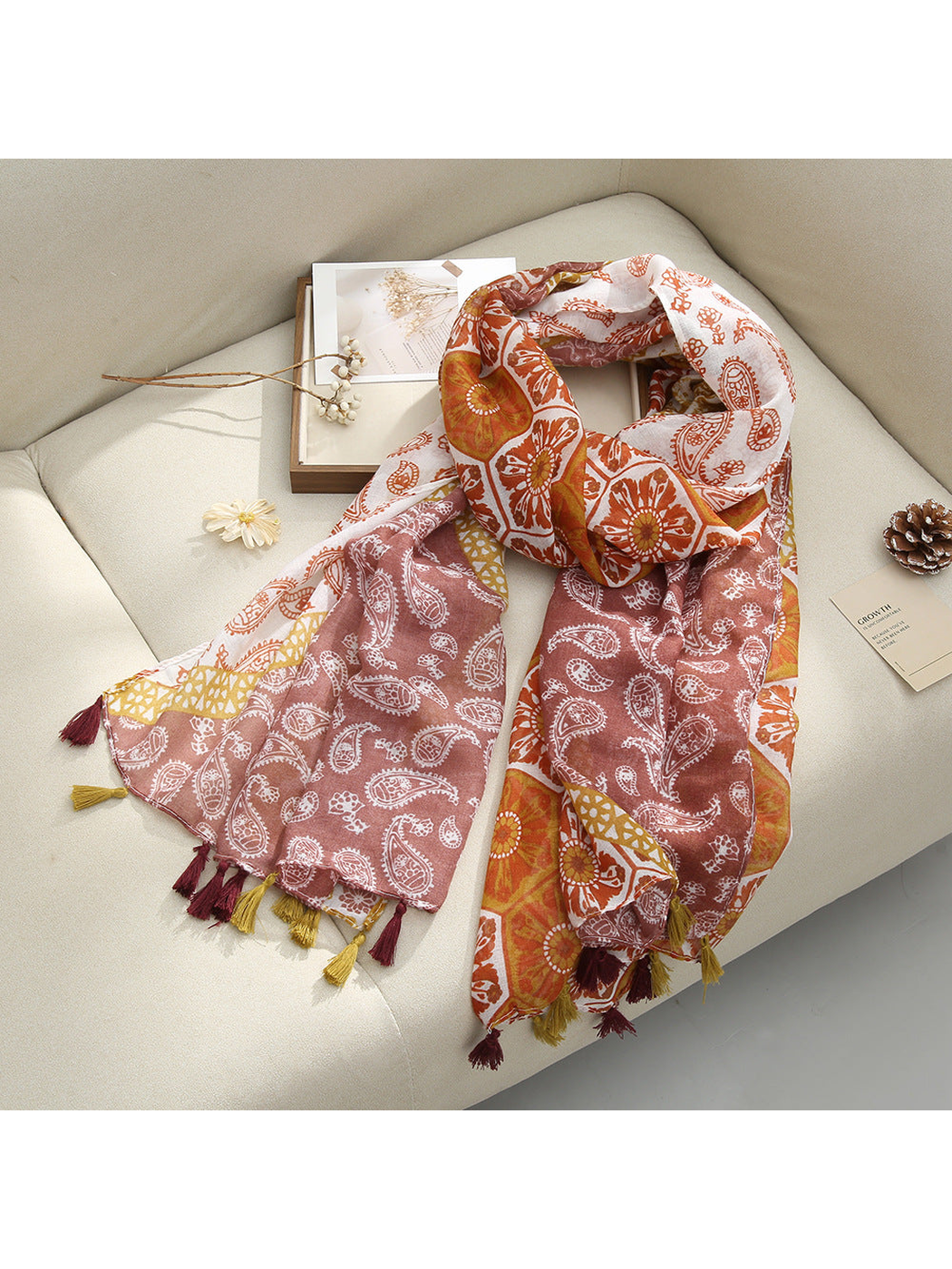 Brown Paisley scarf with paisley and floral patterns and tassel fringe, draped view