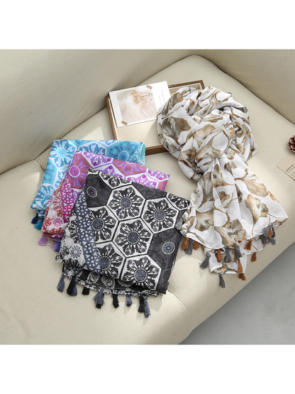 Several scarf styles with paisley, floral, and medallion patterns displayed together