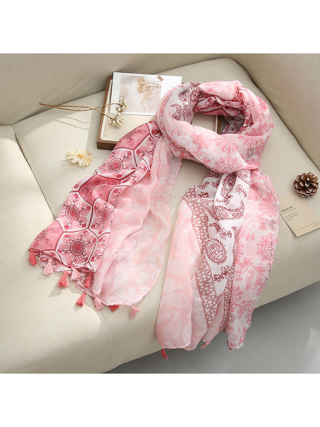 Pink Paisley scarf with paisley and floral patterns and tassel fringe, draped view