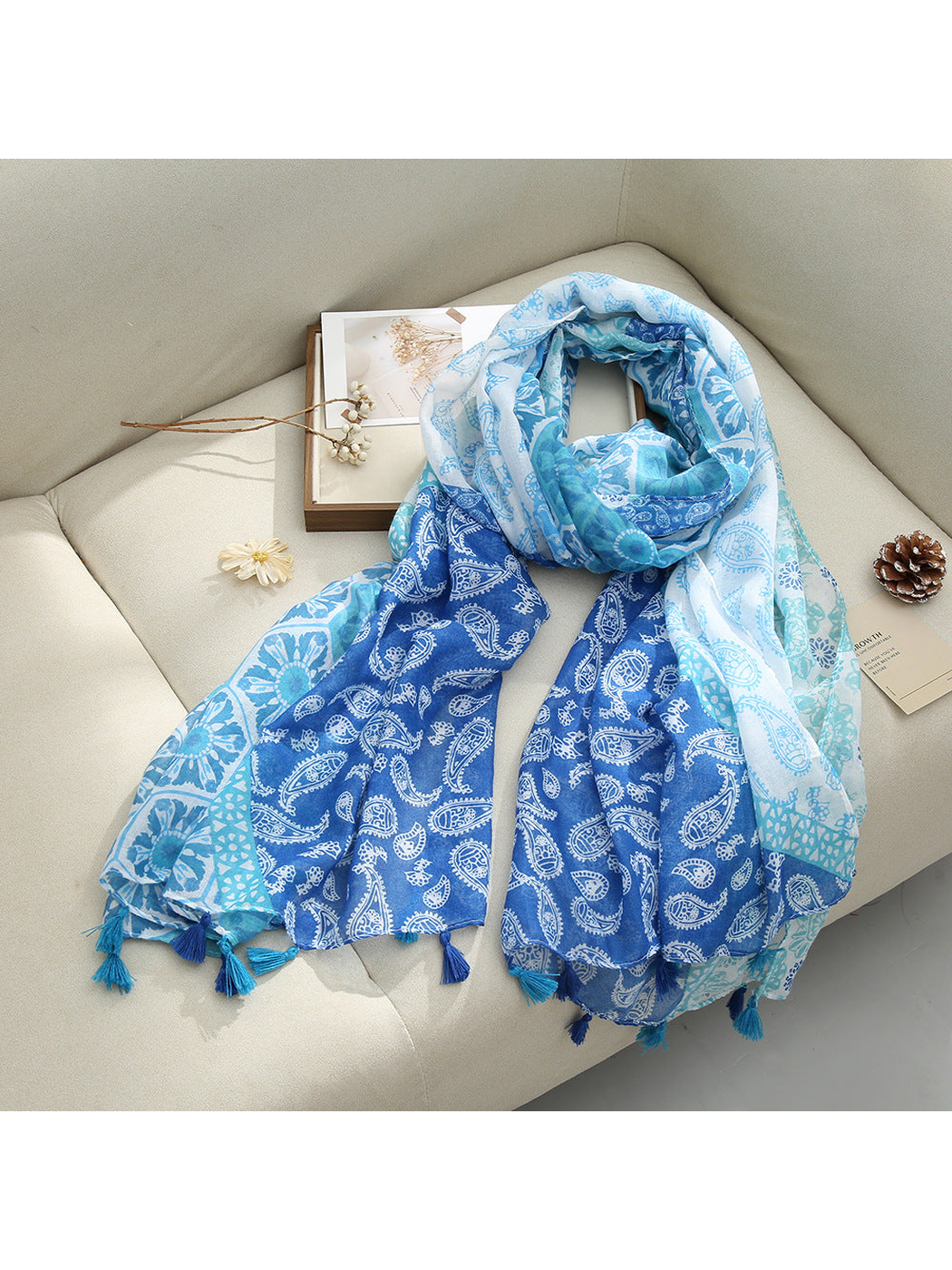 Blue Paisley scarf with paisley and floral patterns and tassel fringe, draped view