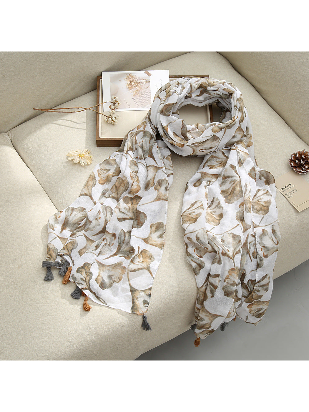 Beige Floral scarf with a floral pattern and tassel fringe, draped view