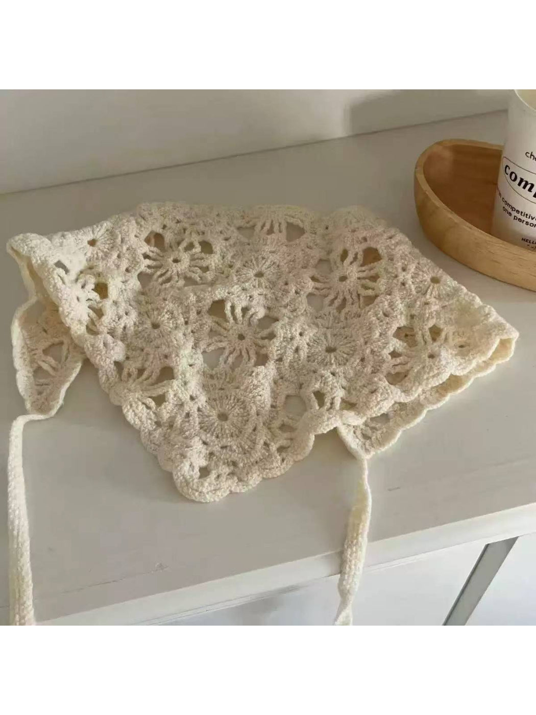 Close-up of the open knit pattern on the cream triangle scarf