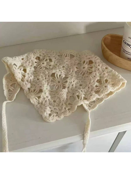 Close-up of the open knit pattern on the cream triangle scarf