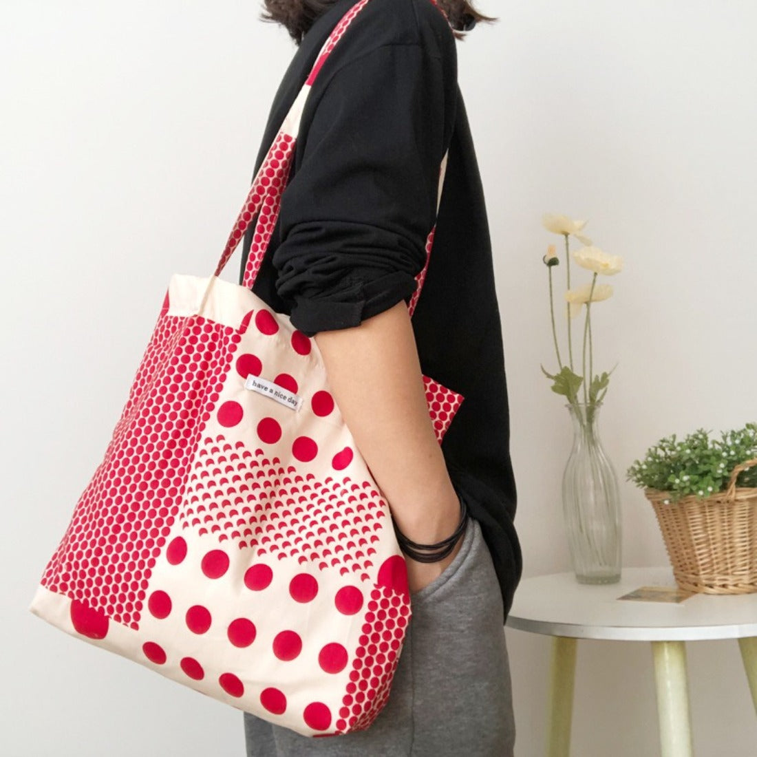 Cosbai tote bag being carried by a model, highlighting size and style