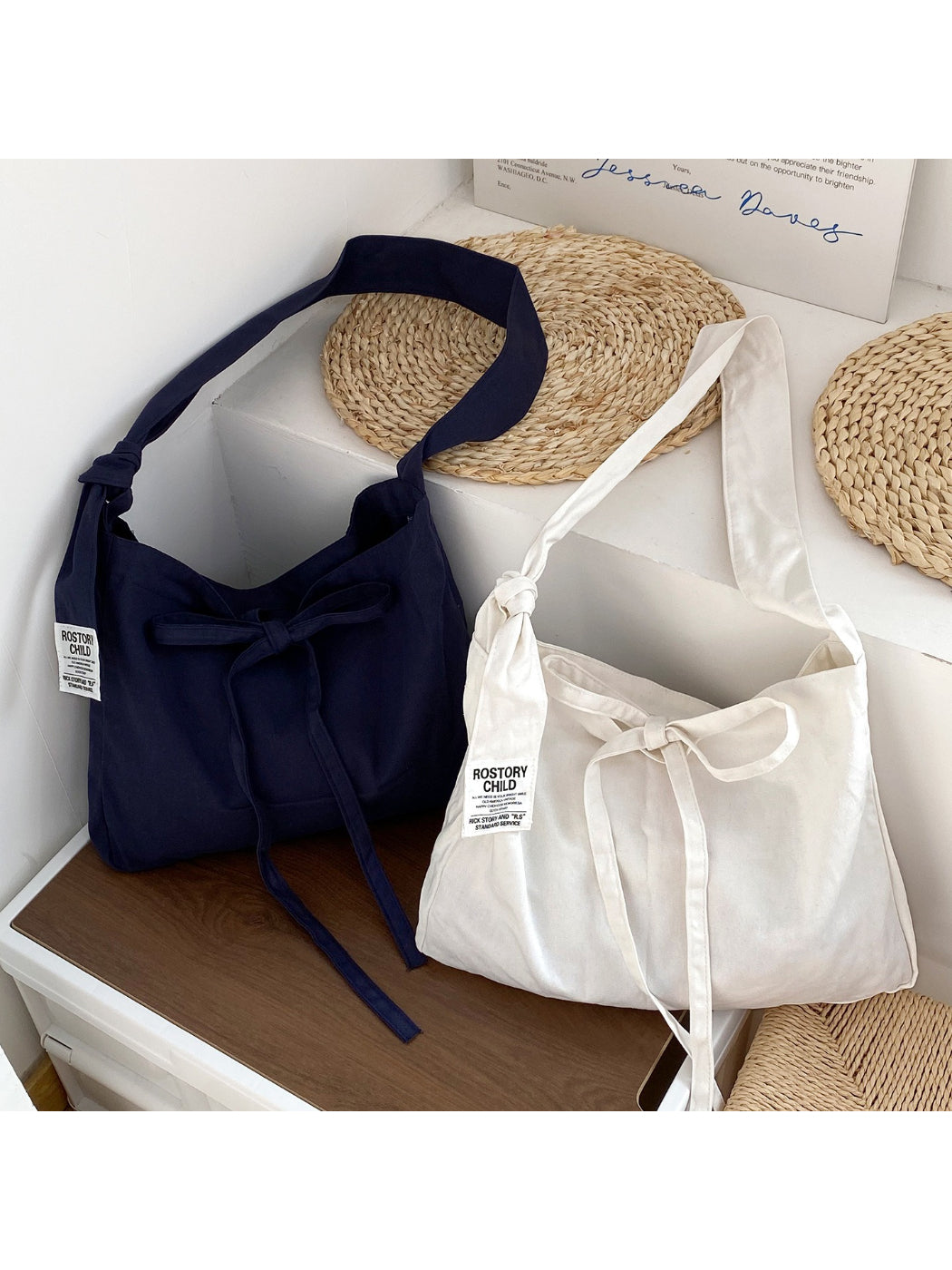 Cosbai slouchy shoulder bag in beige with tied shoulder strap, front view