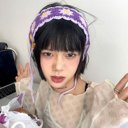 Model smiling wearing crochet flower hairband with casual summer dress