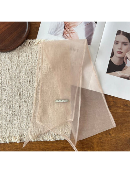 Scarf styled as a headband on model with hair pulled back, highlighting lightweight fabric