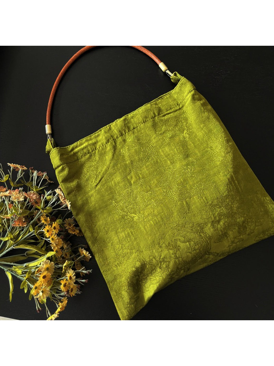 Vintage olive slouch tote bag styled with casual outfit on model