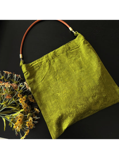 Vintage olive slouch tote bag styled with casual outfit on model
