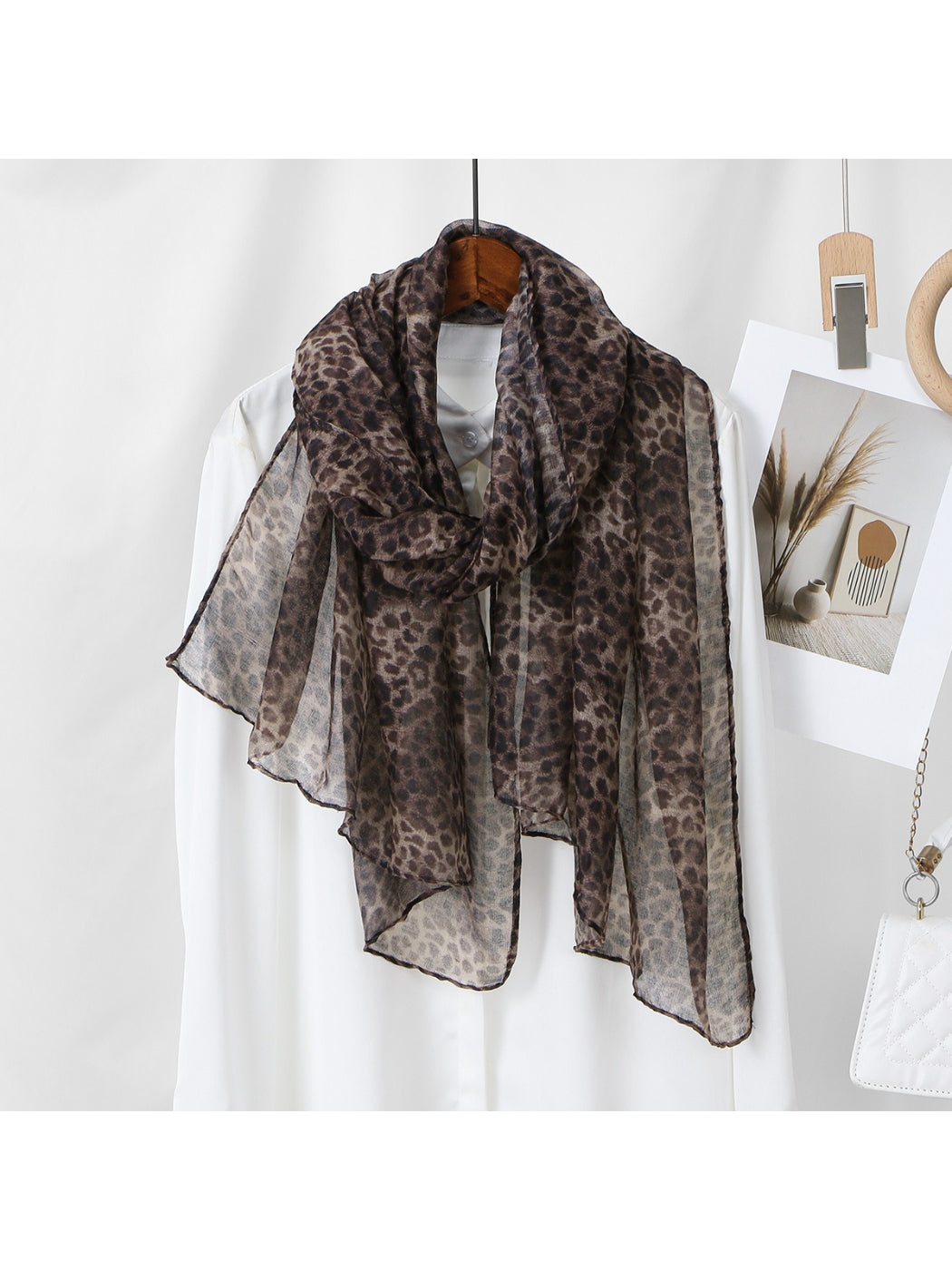 Scarf draped over a mannequin highlighting the leopard pattern