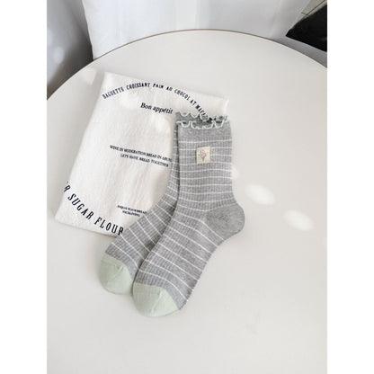 Model wearing Rufia Lettuce Edge Stripe Crew Socks with casual shoes