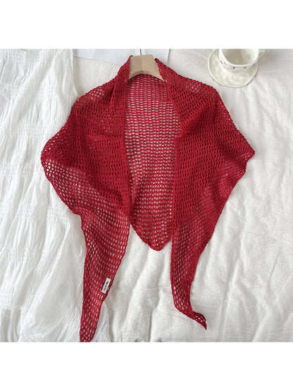 Model wearing crochet triangle shawl scarf styled over casual outfit