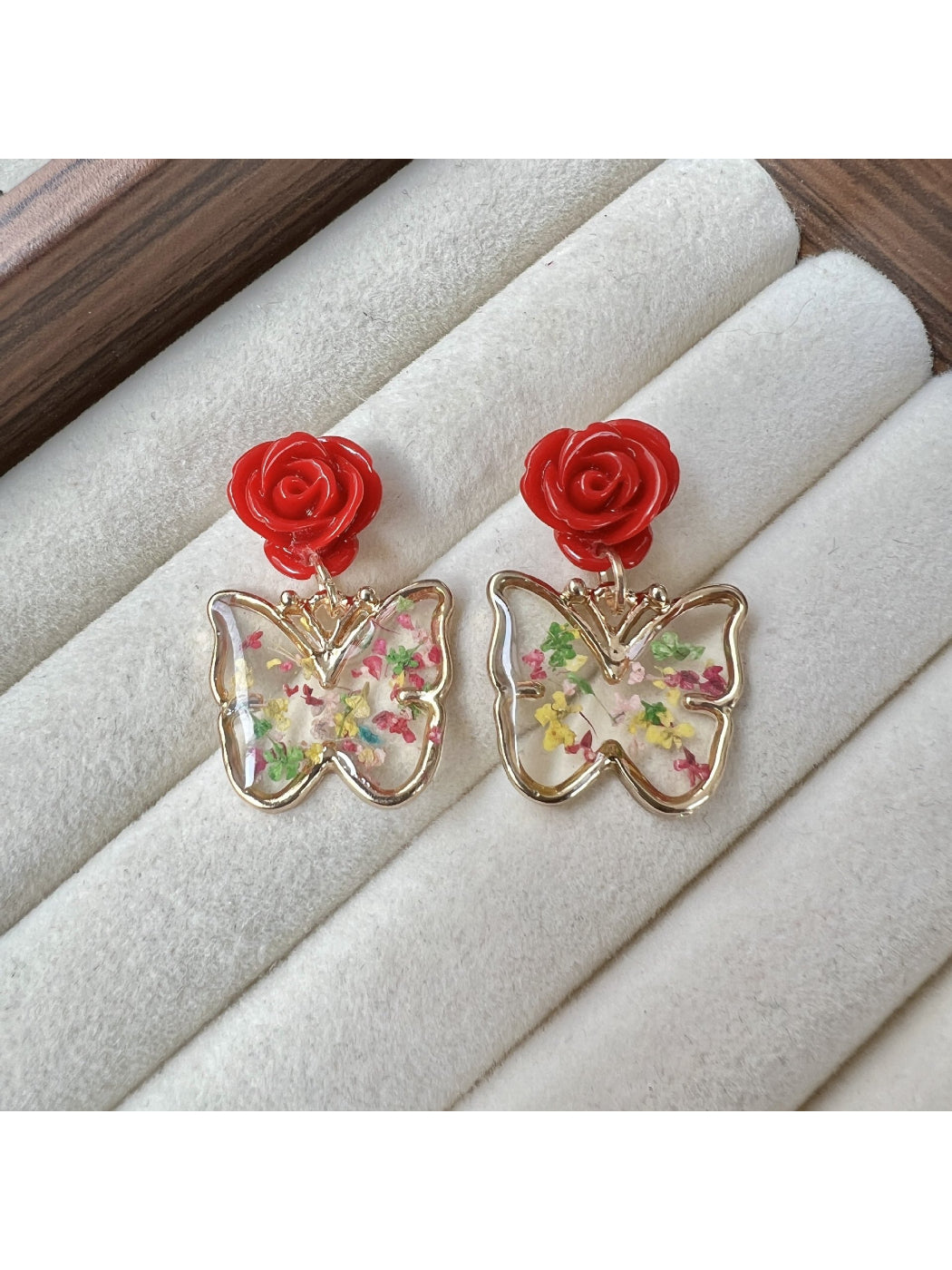 Detailed shot of Earwish Rose Butterfly Drop Earrings focusing on craftsmanship and colors