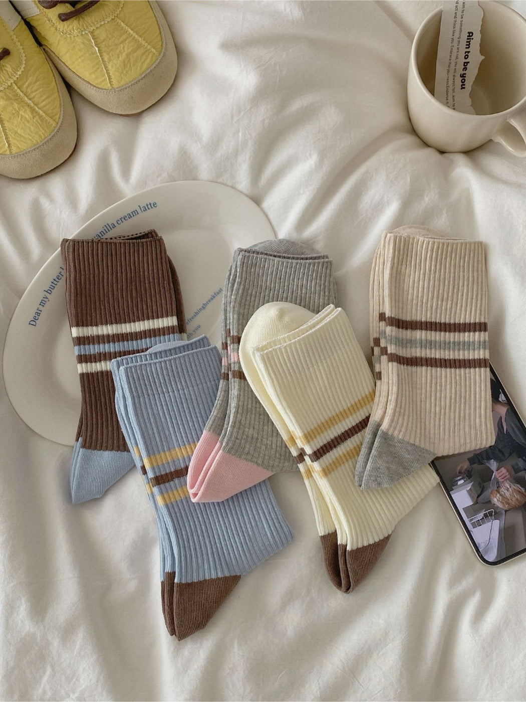 Pair of Rufia colour block ribbed socks in pastel pink, blue, and cream laid flat