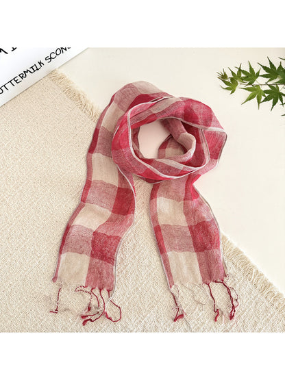 Model wearing soft check pattern long skinny scarf styled around the neck