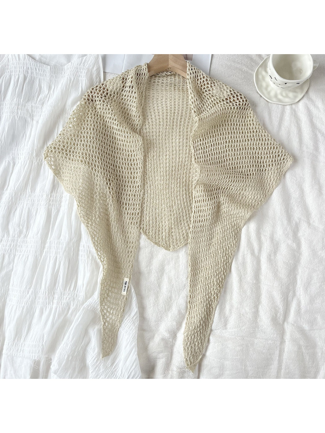 Detailed view of yarn texture and crochet pattern on triangle shawl scarf
