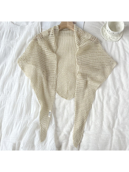 Detailed view of yarn texture and crochet pattern on triangle shawl scarf