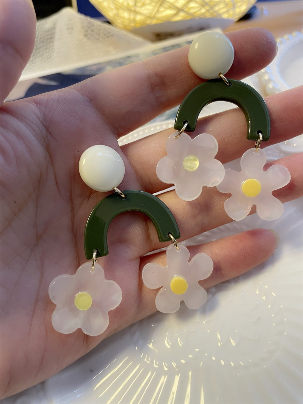 Model wearing green arch daisy earrings showing size and fit