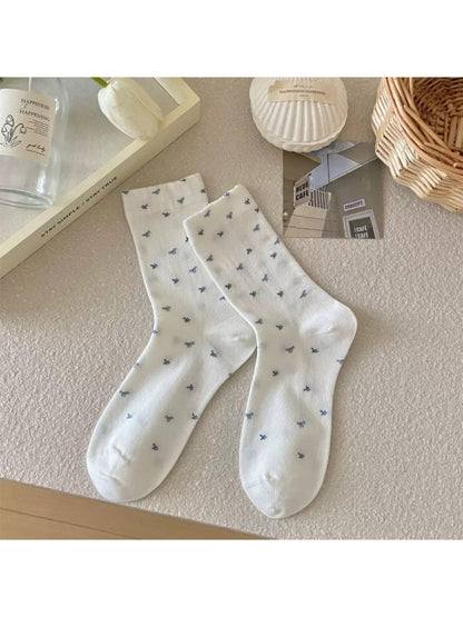 Rufia crew socks folded to show heart butterfly and plaid details