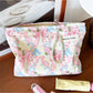 Cosbai cosmetic bag with bow and floral pattern on a white surface