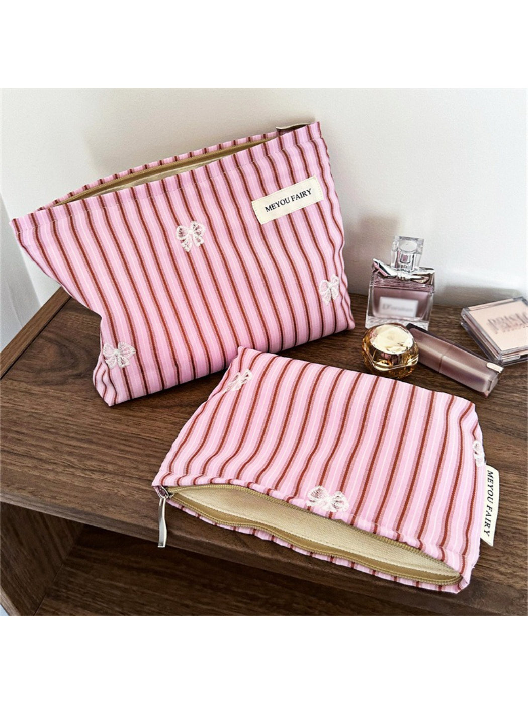 Pink stripe butterfly makeup bag standing upright partially open