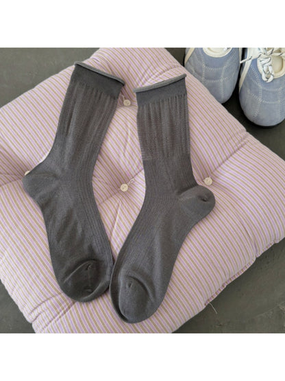 Rufia soft knit crew socks folded neatly on wooden surface